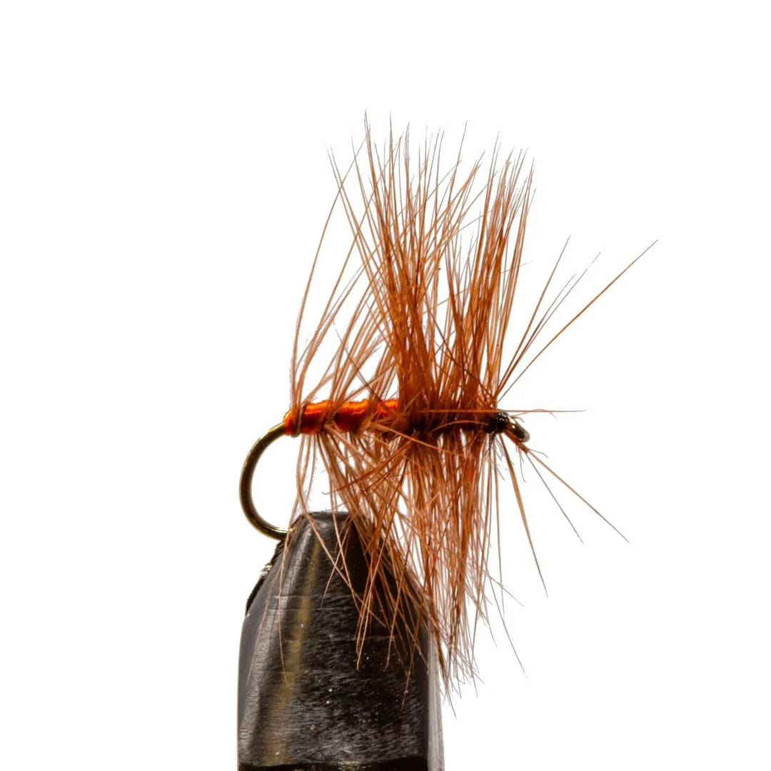Fishing fly with brown fibers on a white background