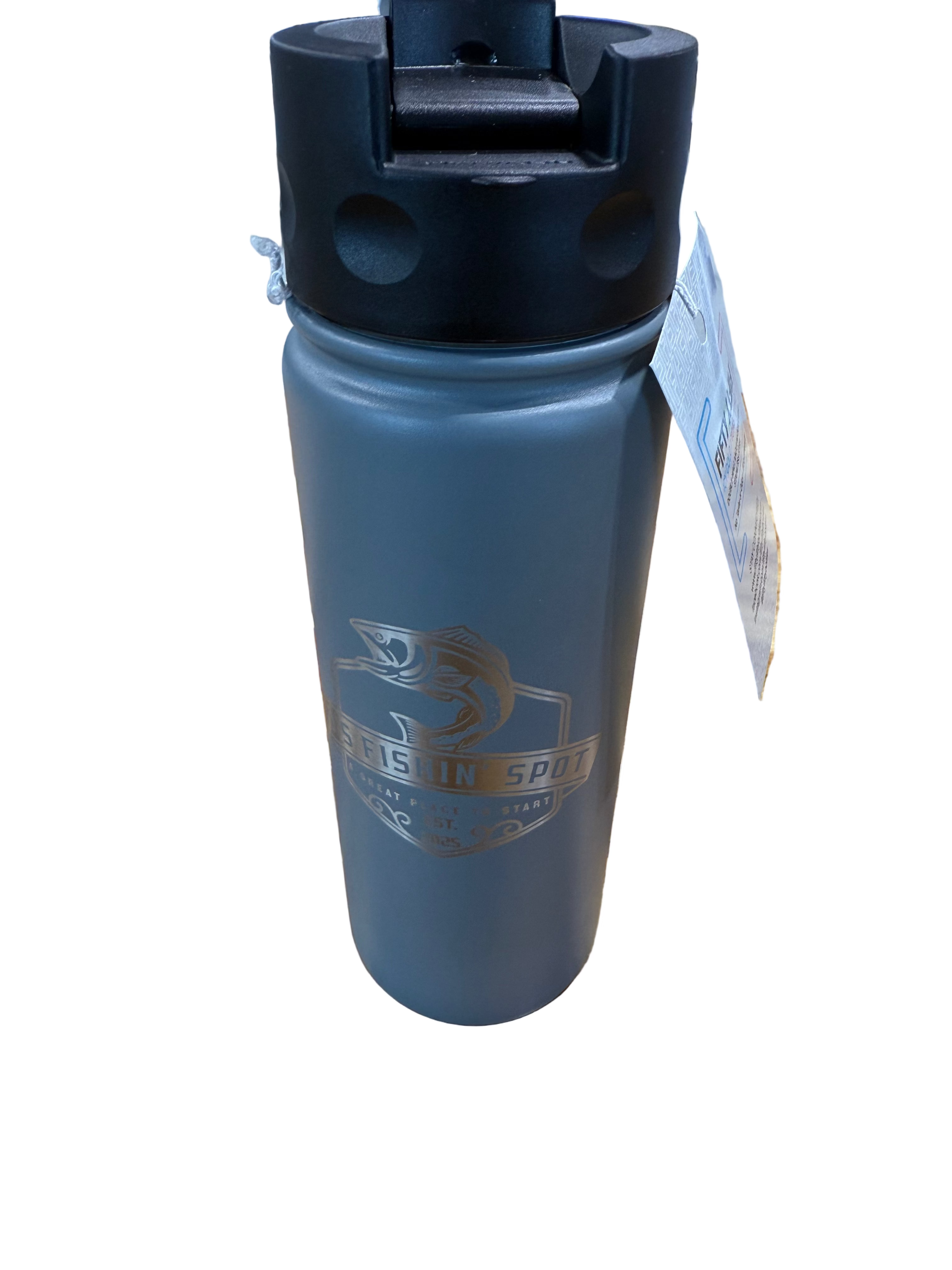 Gray tumbler with black lid on a wooden surface in a store setting